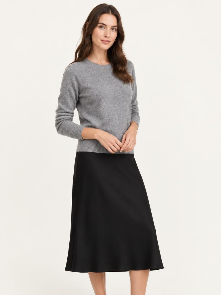 Model in a grey marle merino crew jumper and black skirt